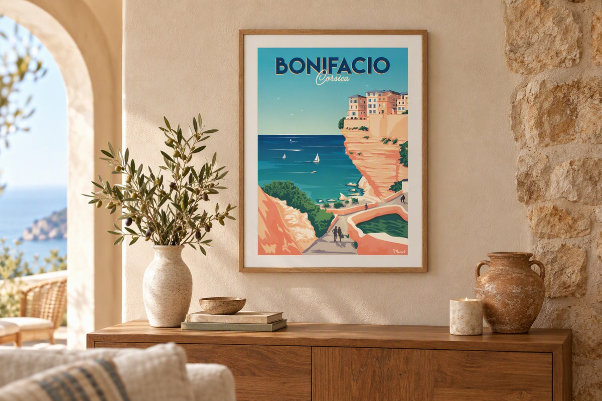Affiche Bonifacio encadrée au-dessus d'un buffet en bois avec branches d'olivier