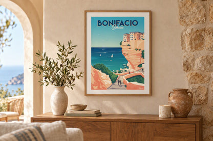 Affiche Bonifacio encadrée au-dessus d'un buffet en bois avec branches d'olivier
